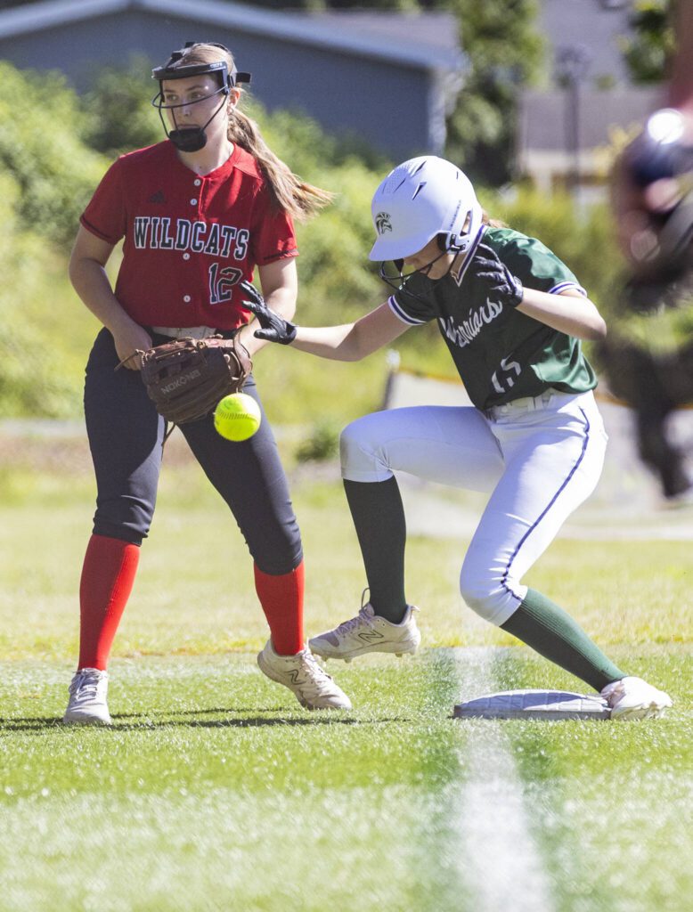 A throw to Archbishop Murphy’s Audrey Sommer flies past Edmonds-Woodway’s Abby Tracy as she runs to third base during the game on Monday, May 5, 2025 in Everett, Washington. (Olivia Vanni / The Herald)
