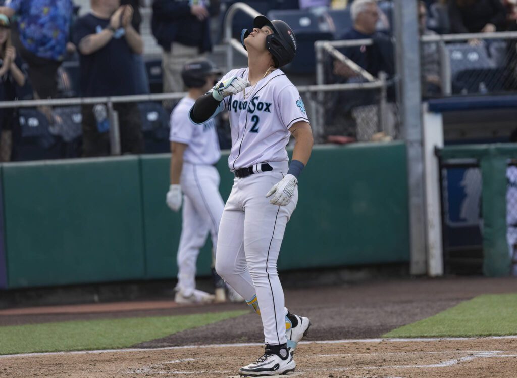 Everett AquaSox infielder Luis Suisbel looks up as he touches first base to score during the game against the Tri-City Dust Devils on Tuesday, May 6, 2025 in Everett, Washington. (Olivia Vanni / The Herald)
