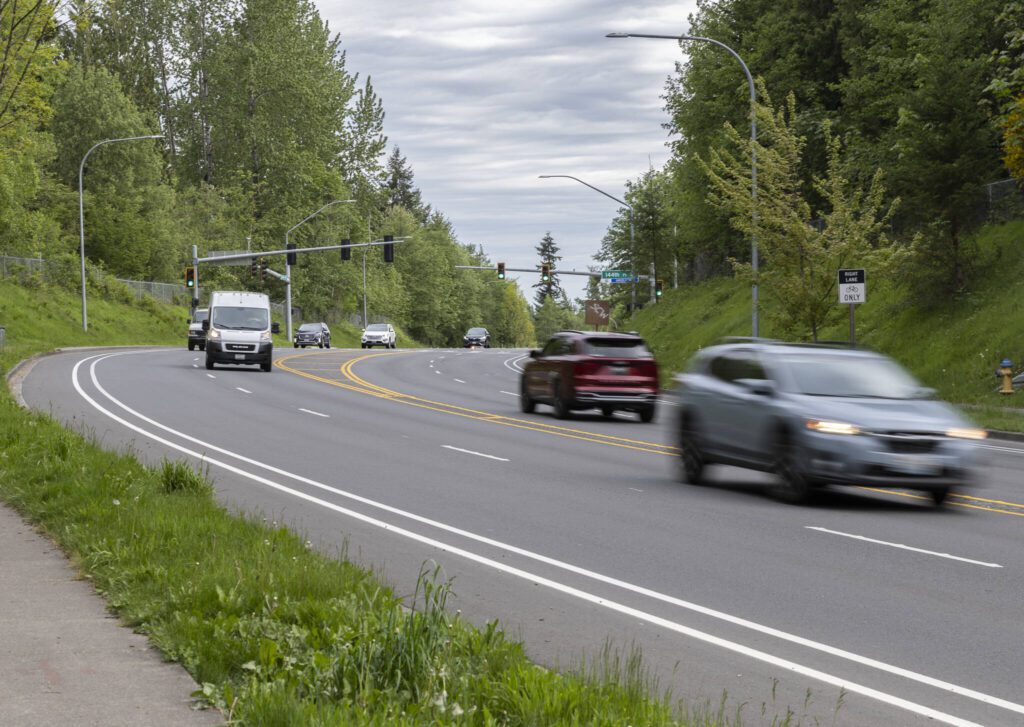 Cars drive along Cathcart Way through the intersection of 144th Place SE on Wednesday, May 7, 2025 in Everett, Washington. (Olivia Vanni / The Herald)
