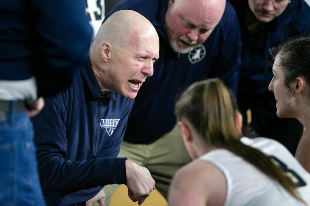 Arlington head coach Joe Marsh talks with his team during a timeout against Lake Washington in a 3A semifinal on Friday, March 3, 2023, at the Tacoma Dome in Tacoma, Washington. (Ryan Berry / The Herald)

