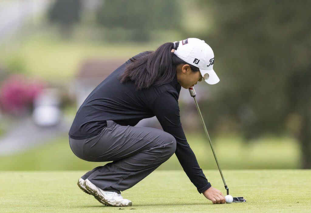 Jackson’s Chanyoung Park sets up her putt during the 4A District 1 Golf Tournament at Snohomish Golf Course on Wednesday, May 14, 2025 in Snohomish, Washington. (Olivia Vanni / The Herald)
