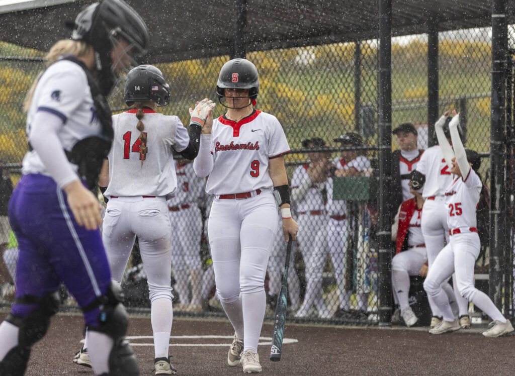 Snohomish’s Madalynn Larsen high-fives Abby Edwards as she walks up to bat during the 3A District 1 consolation game against Edmonds-Woodway on Thursday, May 15, 2025 in Snohomish, Washington. (Olivia Vanni / The Herald)
