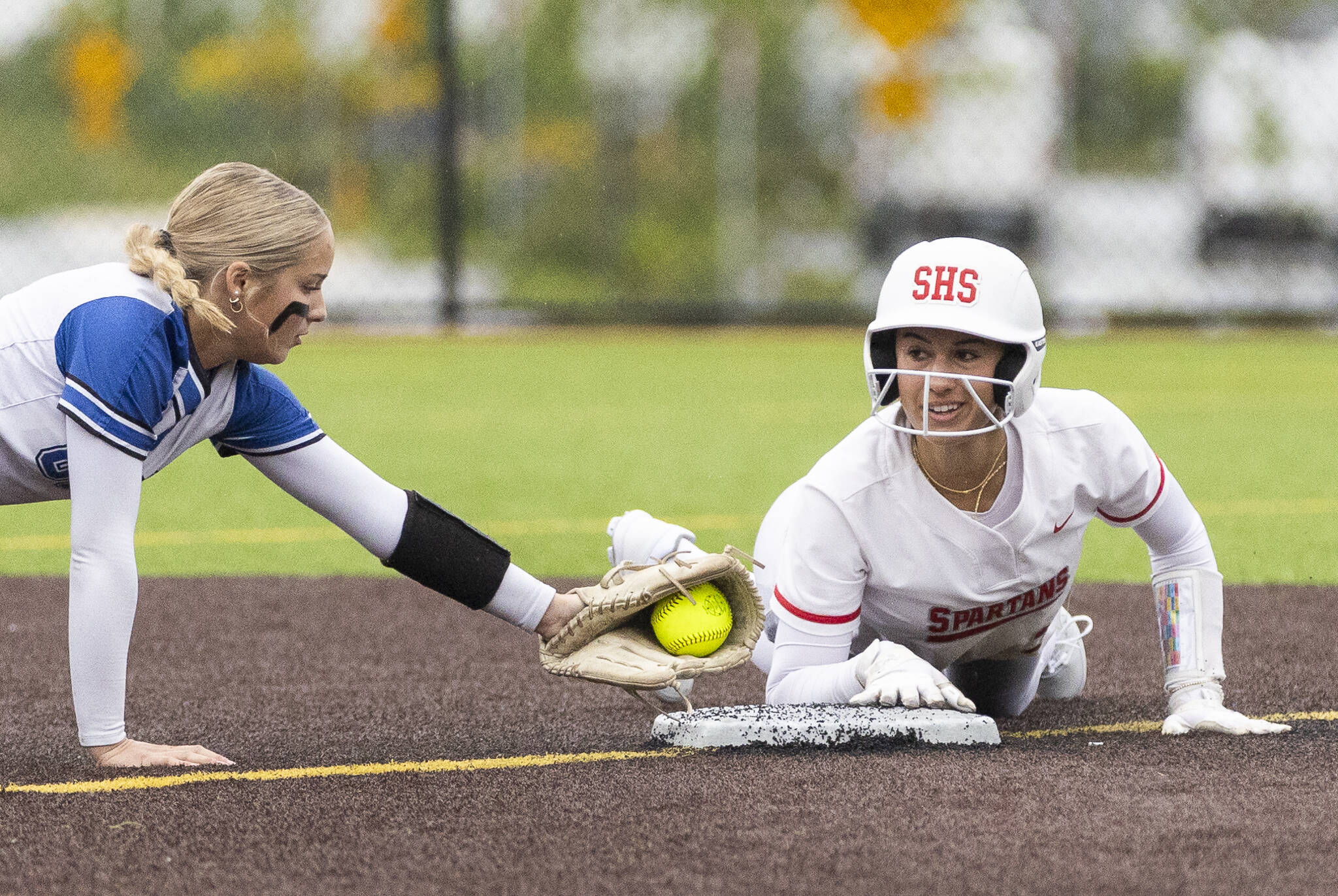 Stanwood’s Rubi Lopez looks up and smiles while being called safe after sliding into second base during the 3A District 1 championship game against Sedro-Woolley on Thursday, May 15, 2025 in Everett, Washington. (Olivia Vanni / The Herald)