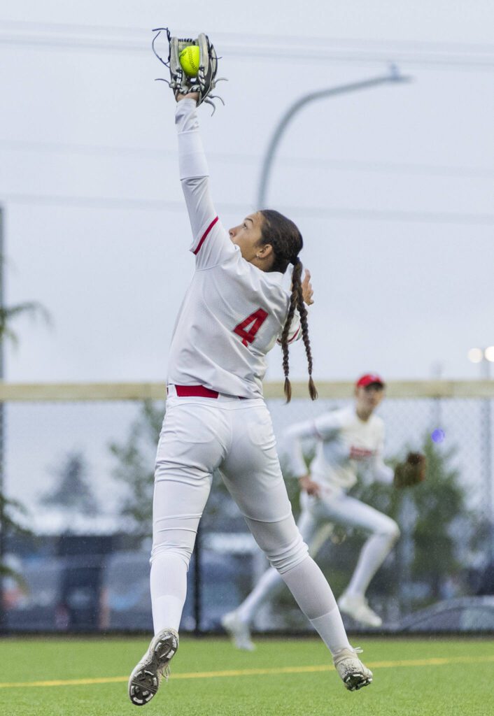 Stanwood’s Taylor Almanza leaps in the air to make a catch for an out during the 3A District 1 championship game against Sedro-Woolley on Thursday, May 15, 2025 in Everett, Washington. (Olivia Vanni / The Herald)
