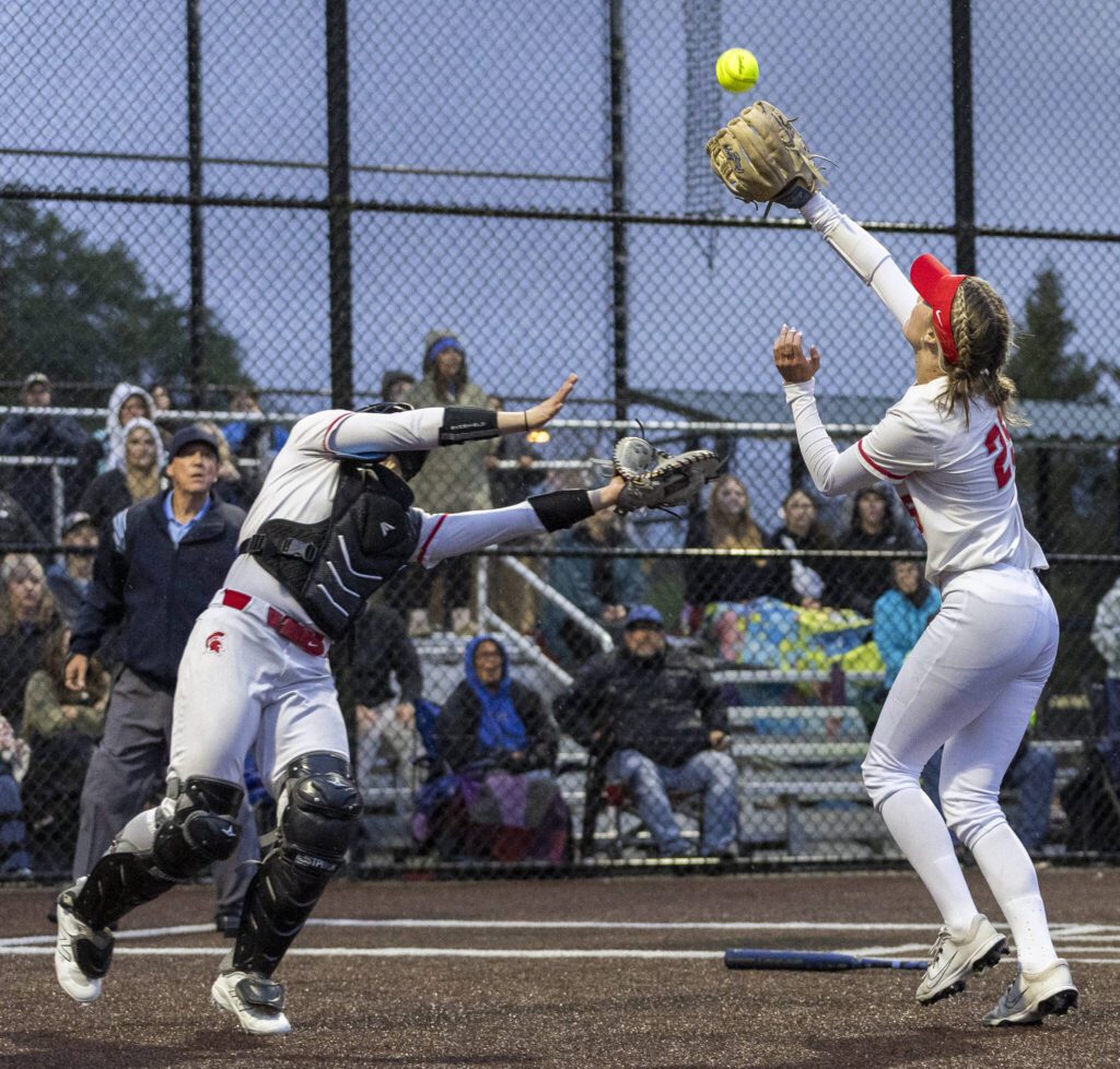 Stanwood’s Jordan Rancourt and Reagan Ryan both run after a pop up during the 3A District 1 championship game against Sedro-Woolley on Thursday, May 15, 2025 in Everett, Washington. (Olivia Vanni / The Herald)
