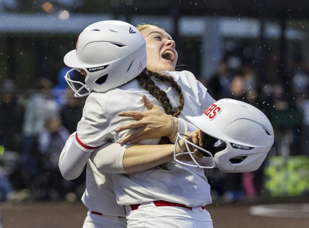 Stanwood’s Addi Anderson hugs her teammate during the 3A District 1 championship game against Sedro-Woolley on Thursday, May 15, 2025 in Everett, Washington. (Olivia Vanni / The Herald)
