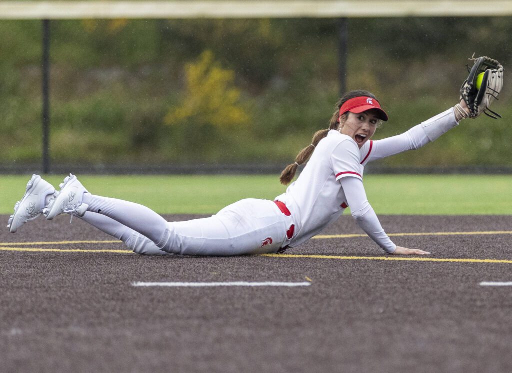 Stanwood’s Rubi Lopez reacts to making a diving catch during the 3A District 1 championship game against Sedro-Woolley on Thursday, May 15, 2025 in Everett, Washington. (Olivia Vanni / The Herald)
