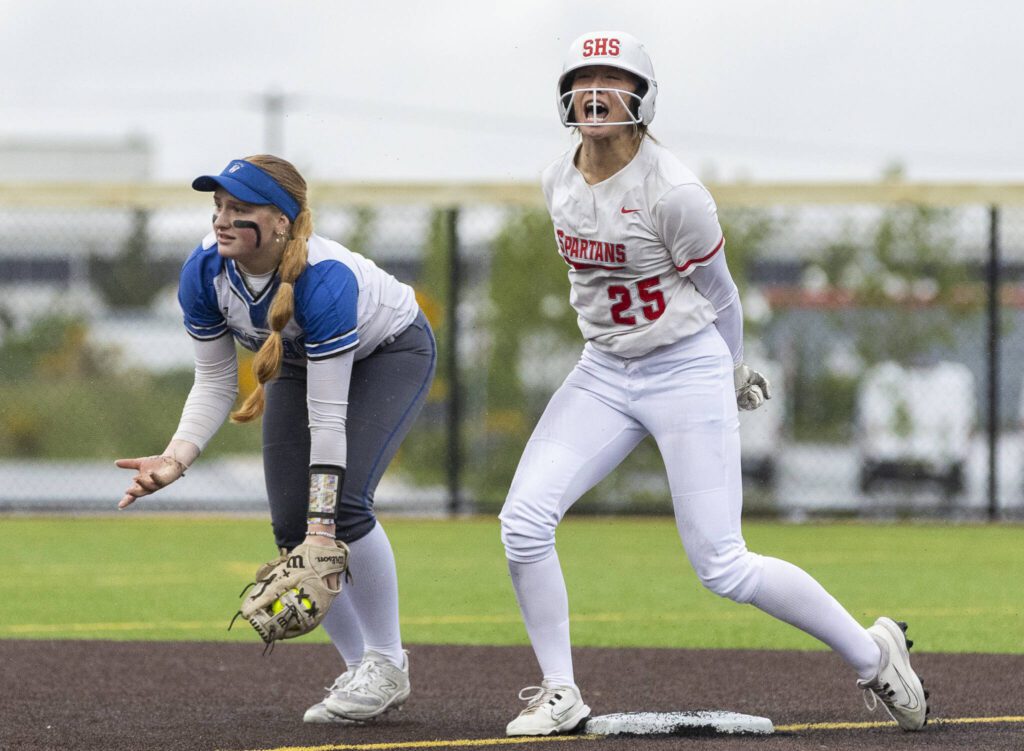 Stanwood’s Reagan Ryan reacts to being called safe after sliding into second base during the 3A District 1 championship game against Sedro-Woolley on Thursday, May 15, 2025 in Everett, Washington. (Olivia Vanni / The Herald)
