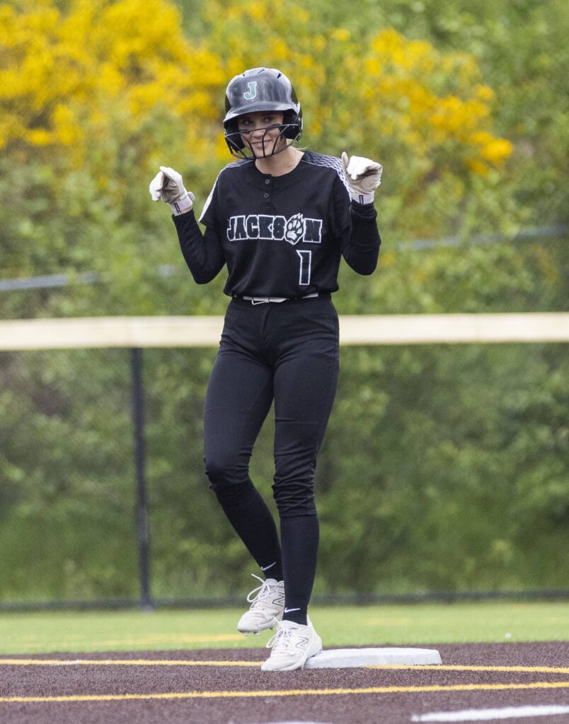 Jackson’s Mia Ediger puts her arms up after making it to second base during the 4A District 1 game against Lake Stevens on Friday, May 16, 2025 in Everett, Washington. (Olivia Vanni / The Herald)
