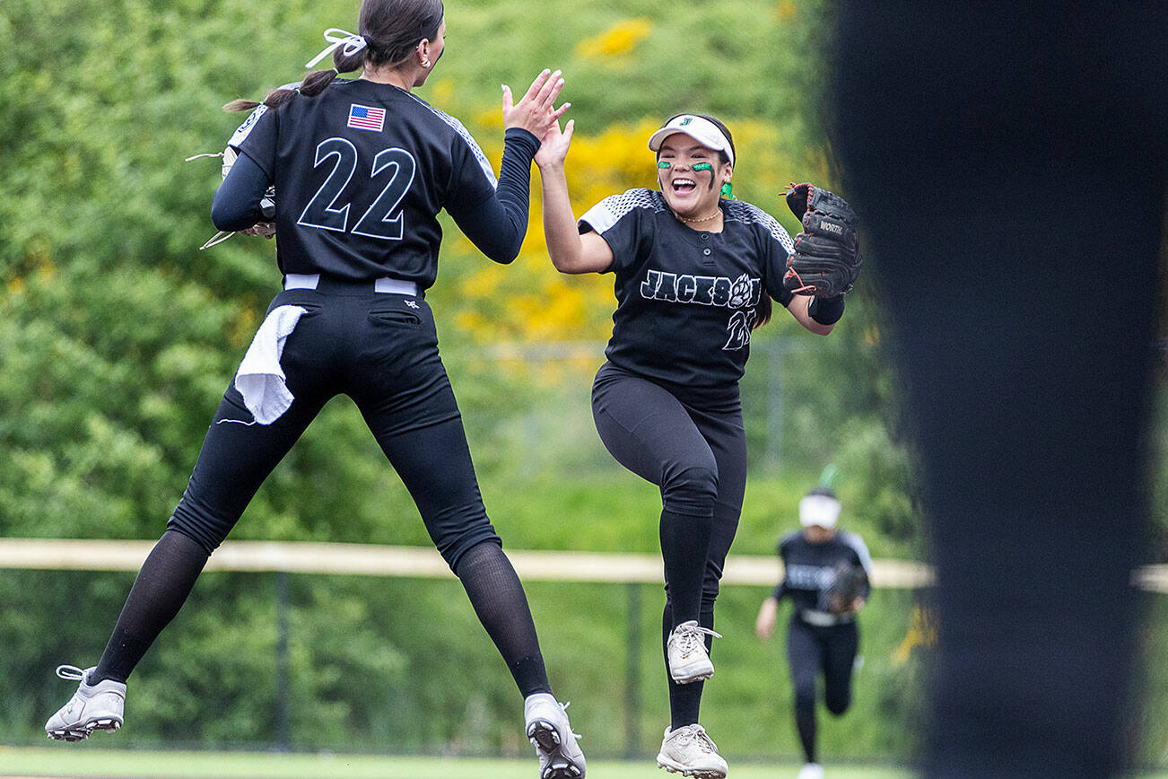 Jackson’s Matea Lopez and Allie Thomsen leap in the air and high five during the 4A District 1 game against Lake Stevens on Friday, May 16, 2025 in Everett, Washington. (Olivia Vanni / The Herald)