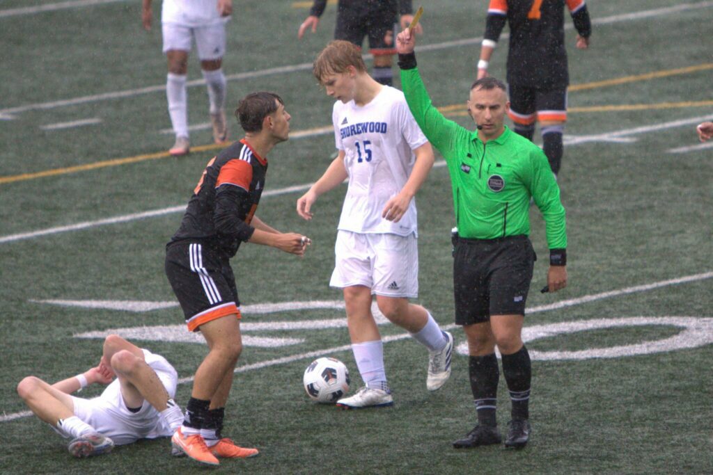 Monroe’s Cody Duncan is assessed a yellow card at the end of the first half during the District 1 3A boys soccer championship game against Shorewood on May 17, 2025 at Shoreline Stadium. (Qasim Ali / The Herald)

