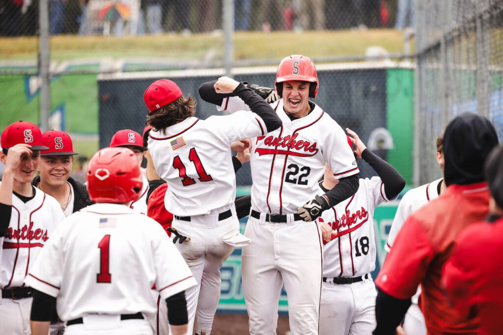 Snohomish sophomore Deyton Wheat (22) celebrates his go-ahead, three-run home run with senior Brayden Holscher (11) during the Panthers’ 4-2 win against Monroe in a District 1 3A consolation game in Woodinville, Washington on May 17, 2025. (Photo courtesy of Brea Bursch / Snohomish Baseball)

