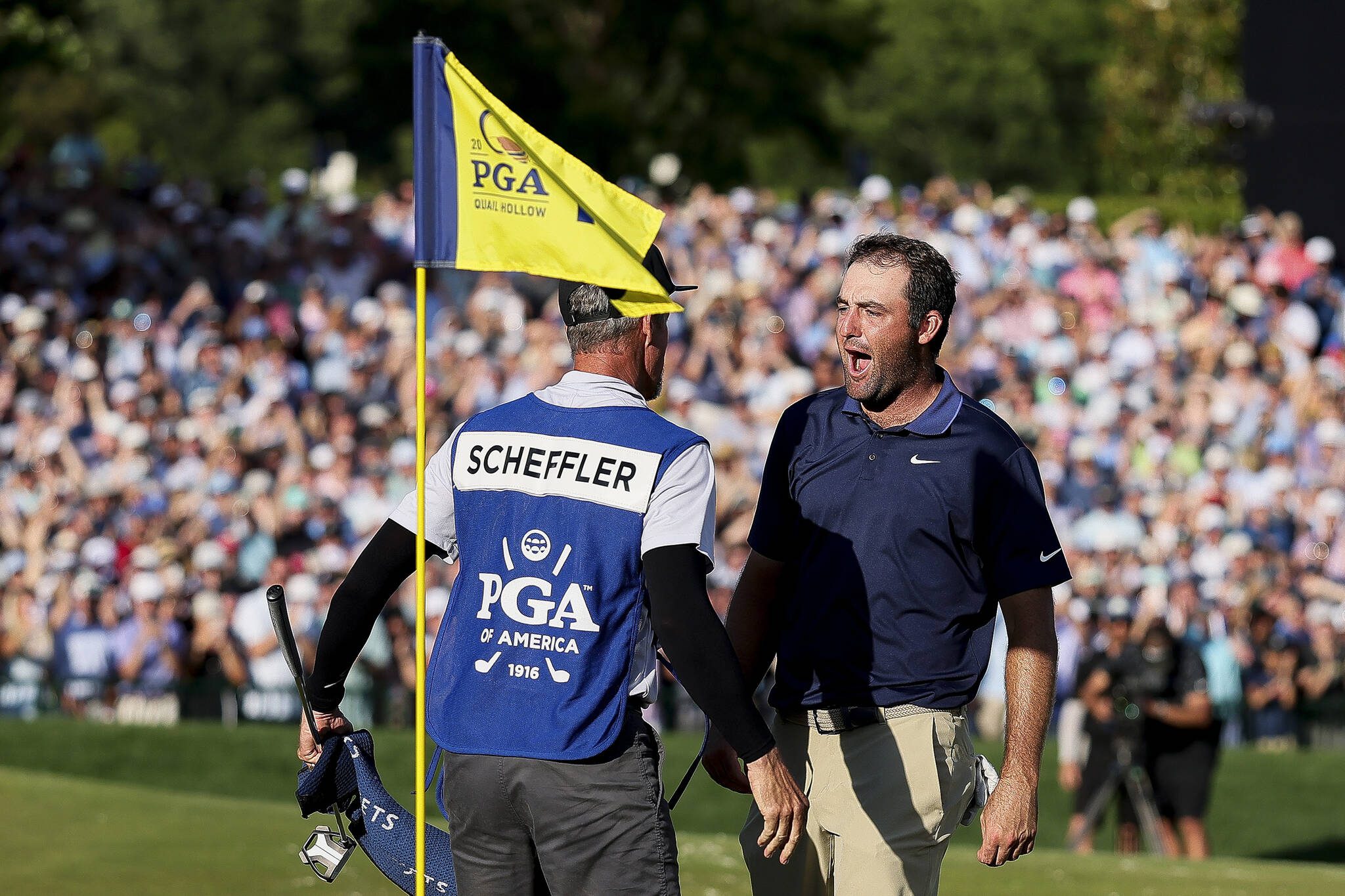 Scottie Scheffler celebrates with his caddie, Ted Scott, on the 18th green after winning the 2025 PGA Championship at Quail Hollow Country Club on Sunday, May 18, 2025, in Charlotte, North Carolina. (Alex Slitz / Getty Images / Tribune News Services)