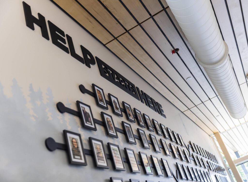 Photographs of employees hang on the wall inside the employee entrance of the new Snohomish County 911 building on Tuesday, May 20, 2025, in Everett, Washington. (Olivia Vanni / The Herald)
