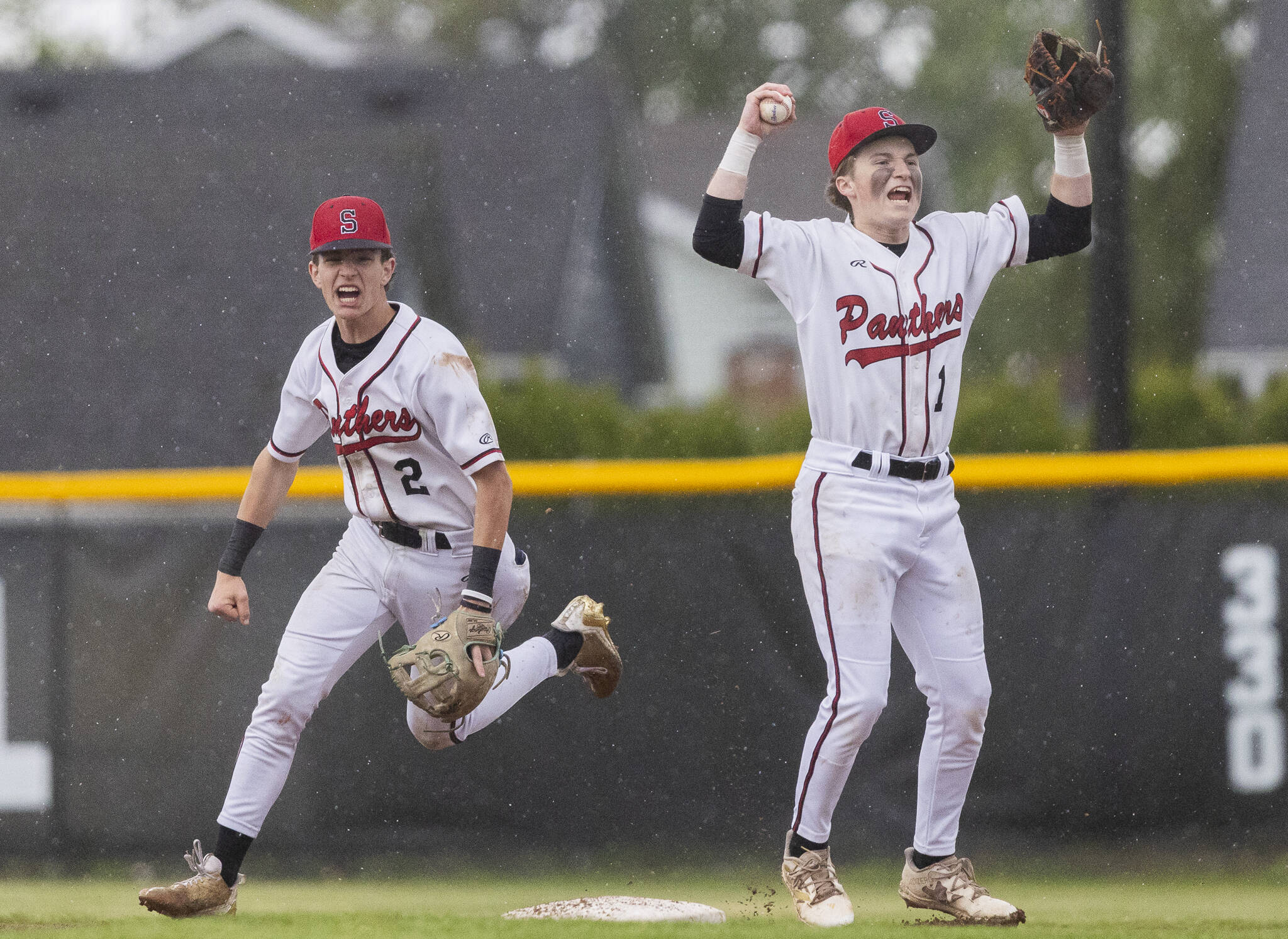 Snohomish’s Griffin Triggs and Chase Clark celebrate getting the final out to beat Bellevue in loser-out opening round 3A state game on Tuesday, May 20, 2025 in Snohomish, Washington. (Olivia Vanni / The Herald)