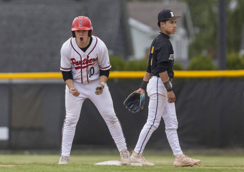 Snohomish’s Enzo Porletto yells after making it to second base during the opening round 3A state game against Bellevue on Tuesday, May 20, 2025 in Snohomish, Washington. (Olivia Vanni / The Herald)
