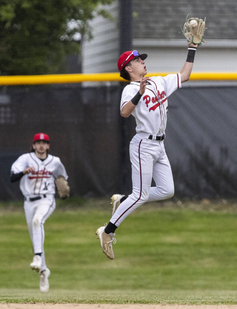 Snohomish’s Griffin Triggs leaps in the air to make a catch during the opening round 3A state game against Bellevue on Tuesday, May 20, 2025 in Snohomish, Washington. (Olivia Vanni / The Herald)
