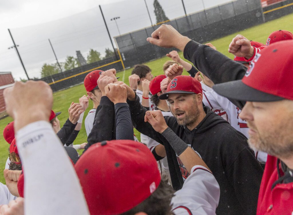 Snohomish head coach Nick Hammons leads his team on a cheer after beating Bellevue in the loser-out opening round 3A state game on Tuesday, May 20, 2025 in Snohomish, Washington. (Olivia Vanni / The Herald)
