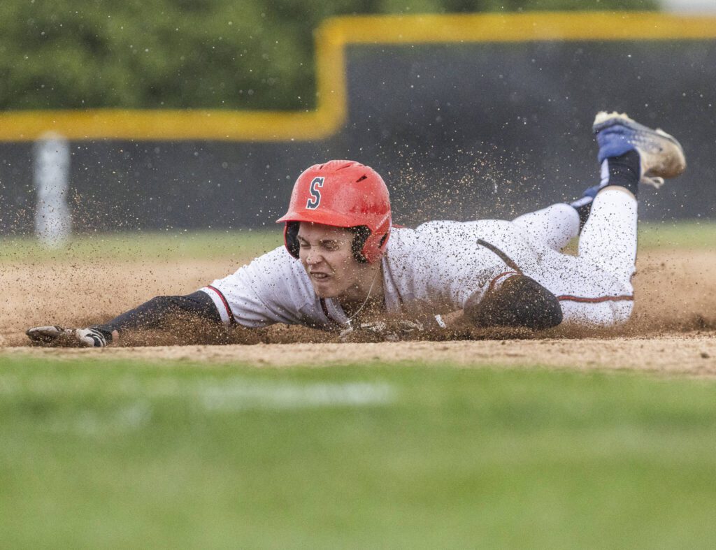 Snohomish’s Deyton Wheat slides into third base during the opening round 3A state game against Bellevue on Tuesday, May 20, 2025 in Snohomish, Washington. (Olivia Vanni / The Herald)
