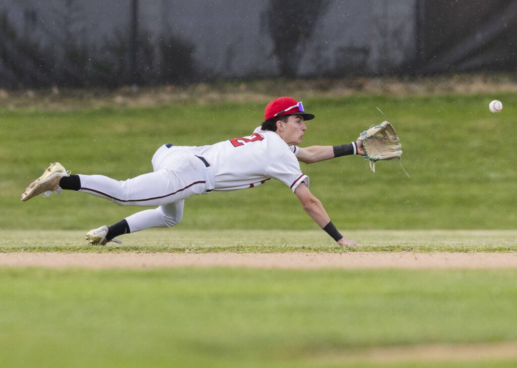 Snohomish’s Griffin Triggs dives to catch the ball during the opening round 3A state game against Bellevue on Tuesday, May 20, 2025 in Snohomish, Washington. (Olivia Vanni / The Herald)
