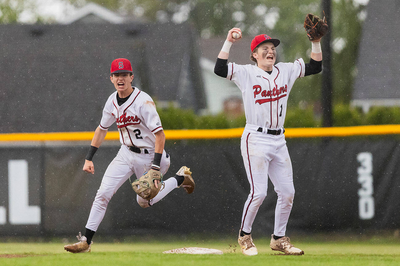 Snohomish’s Griffin Triggs and Chase Clark celebrate getting the final out to beat Bellevue in loser-out opening round 3A state game on Tuesday, May 20, 2025 in Snohomish, Washington. (Olivia Vanni / The Herald)