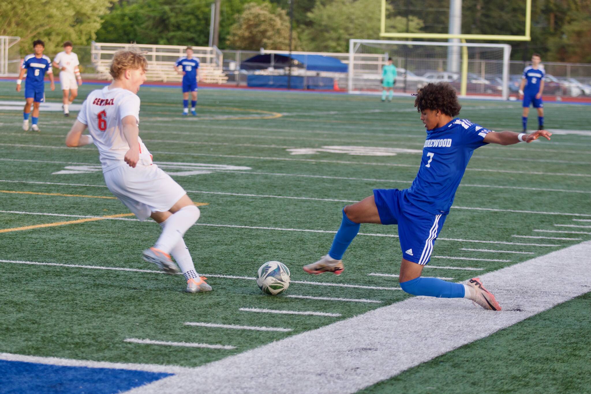 Shorewood senior Matthew Bereket (right) lunges in to challenge a kick from Central Kitsap freshman Eli Daniels during the Stormrays' 1-0 win in the 3A Boys Soccer State Round of 16 in Shoreline, Washington on May 22, 2025. (Joe Pohoryles / The Herald)