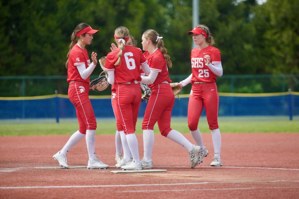 Stanwood sophomore Addi Anderson (second from right) and the Stanwood infielders — sophomore Jemma Lopez, senior Rubi Lopez, junior Taylor Almanza and senior Reagan Ryan — gather in the circle between at-bats during the Spartans’ 3-0 win against Roosevelt in the 3A State Softball Round of 16 in Lacey, Washington on May 23, 2025. (Joe Pohoryles / The Herald)
