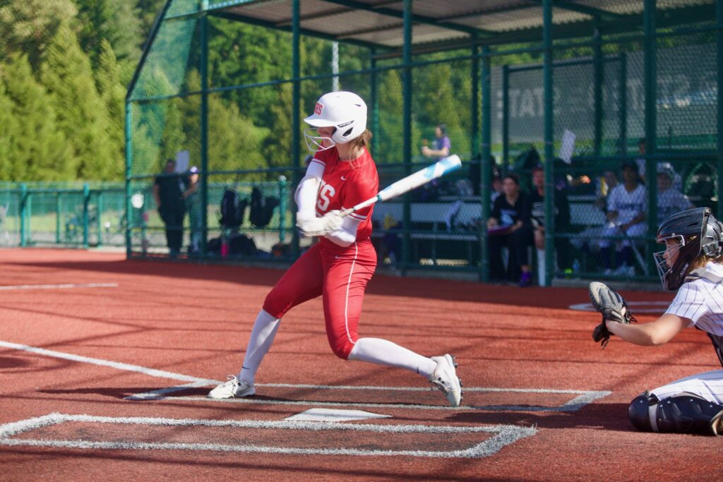 Stanwood senior Reagan Ryan swings at a pitch before hitting a single in the Spartans’ 5-4 loss to Garfield in the 3A State Softball quarterfinals in Lacey, Washington on May 23, 2025. (Joe Pohoryles / The Herald)
