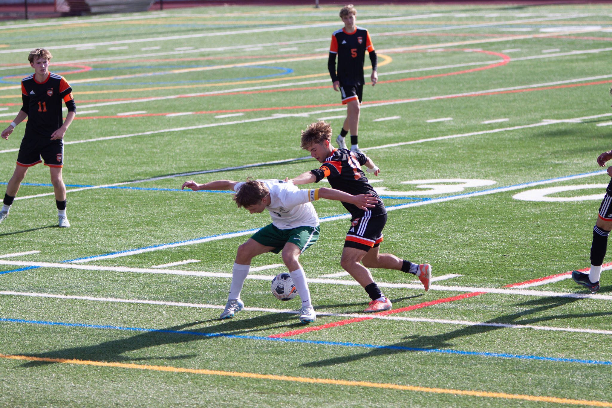 Edmonds-Woodway's Alex Plumis wards off Monroe's Cody Duncan during a 3A State second-round game on May 23, 2025 at Mercer Island High School. (Qasim Ali / The Herald)