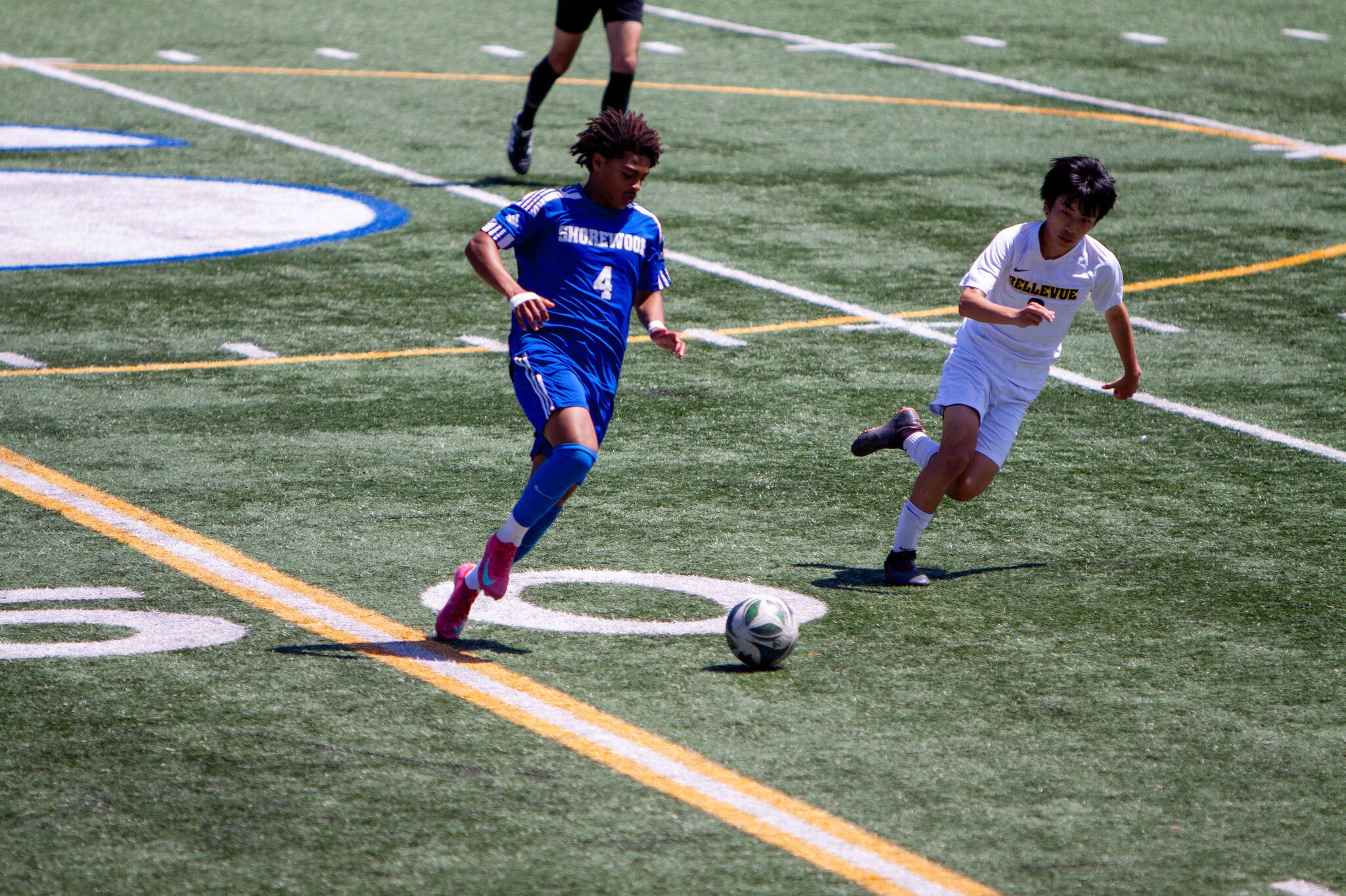 Shorewood's Meiron Bereket dribbles past Bellevue's Masora Takashima during a 3A State boys soccer quarterfinal game on May 24, 2025 at Shoreline Stadium. (Qasim Ali / The Herald)
