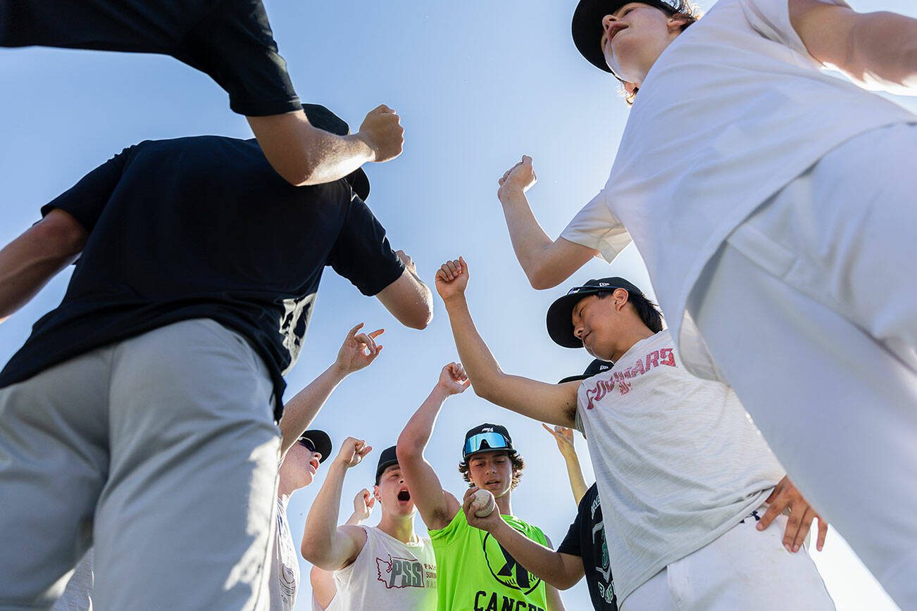Jackson baseball players cheer before starting their next exercise during practice on Wednesday, May 28, 2025 in Mill Creek, Washington. (Olivia Vanni / The Herald)