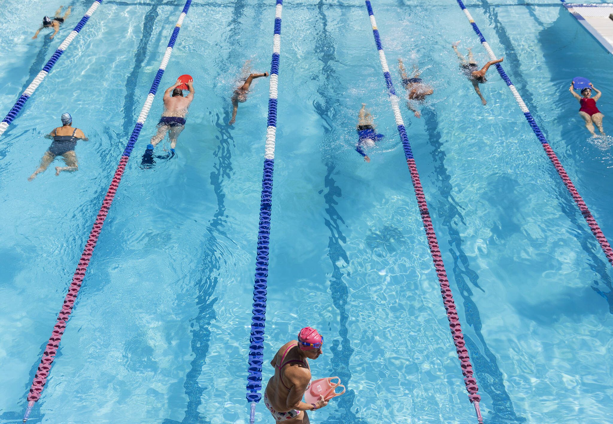People swim in the Yost Pool during Open Fitness and Lap Swim on Tuesday, May 27, 2025 in Edmonds, Washington. (Olivia Vanni / The Herald)