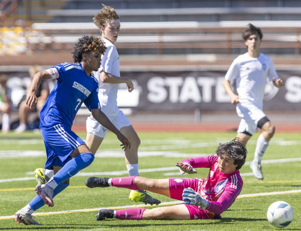 Shorewood’s Matthew Bereket knocks the ball past Ingraham’s keeper during the 3A state semifinal game on Friday, May 30, 2025 in Puyallup, Washington. (Olivia Vanni / The Herald)

