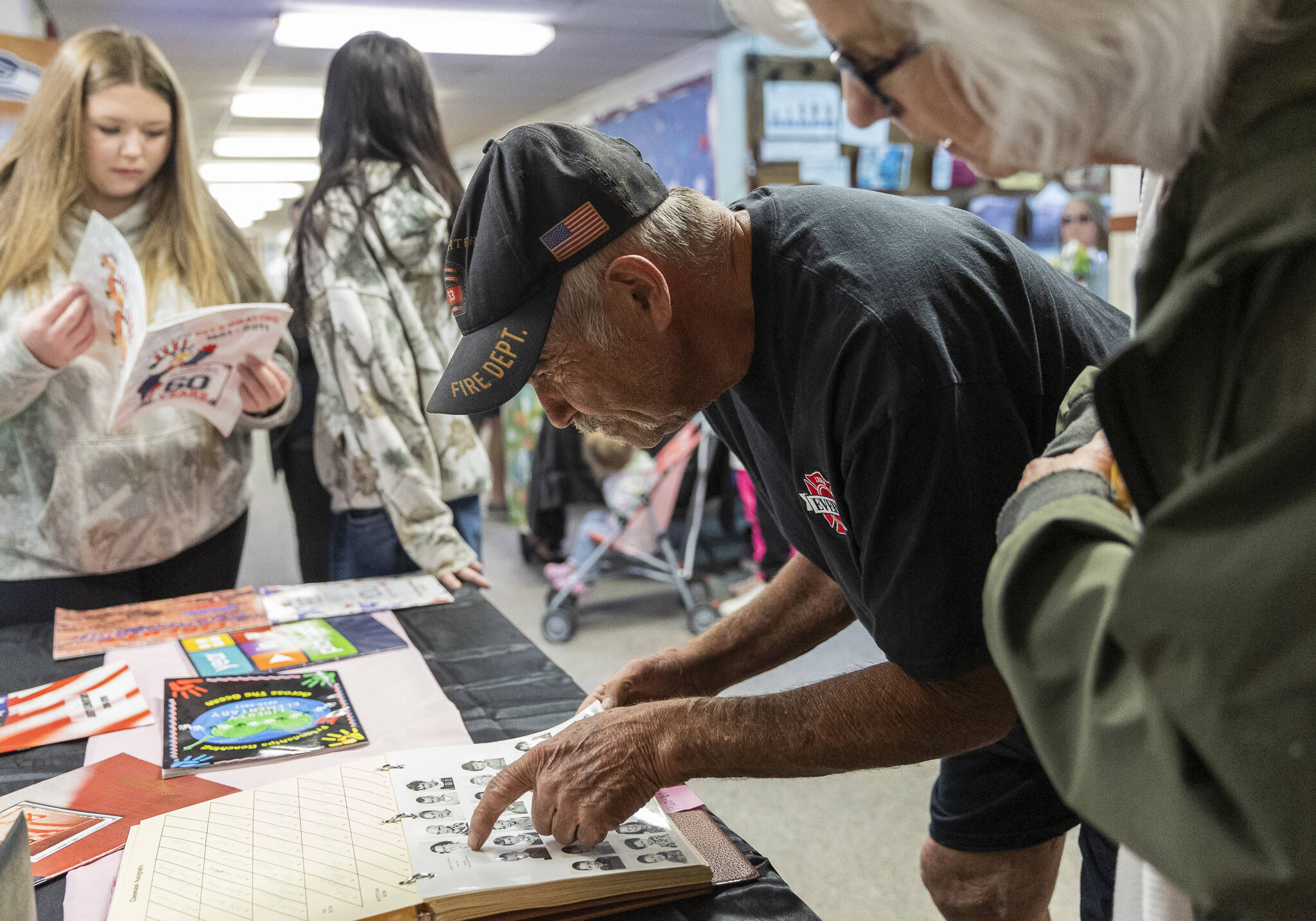 Brian Murril, who started at Liberty Elementary as a kindergartner in 1963, looks for his yearbook photograph during an open house for the public to walk through the school before its closing on Thursday, May 29, 2025 in Marysville, Washington. (Olivia Vanni / The Herald)