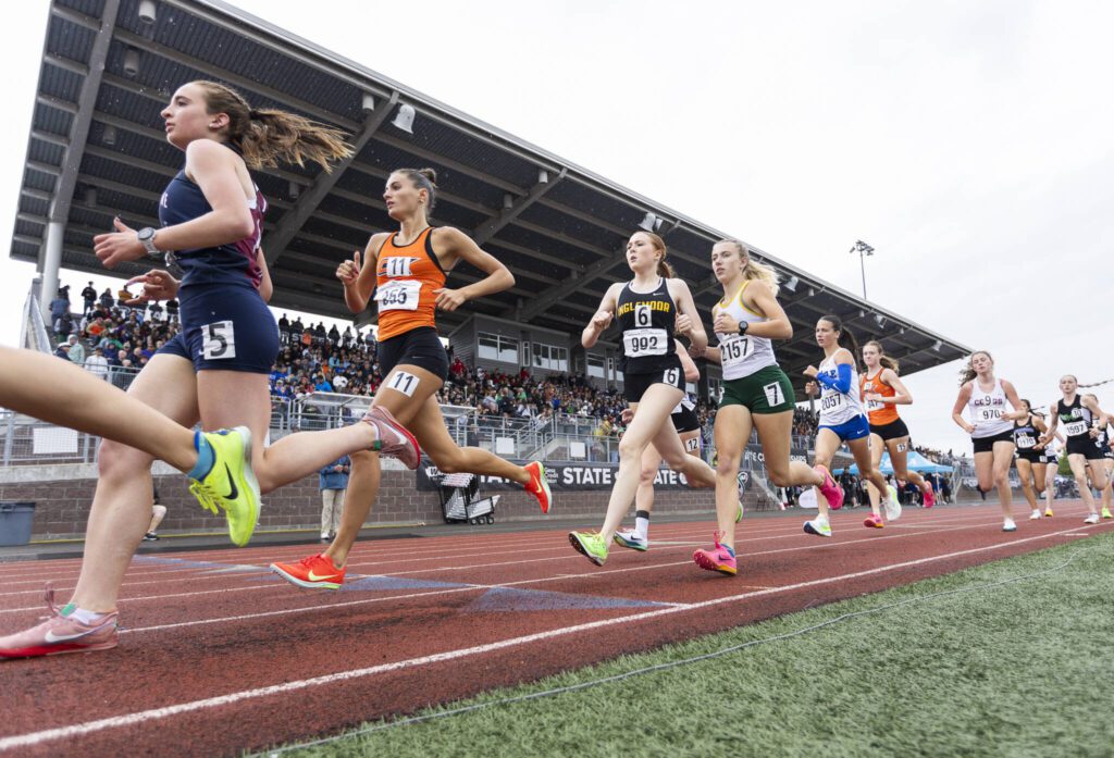 Runners pass by the stands at Mt. Tahoma high school in the 3A girls 3200 meter final on Saturday, May 31, 2025 in Tacoma, Washington. (Olivia Vanni / The Herald)
