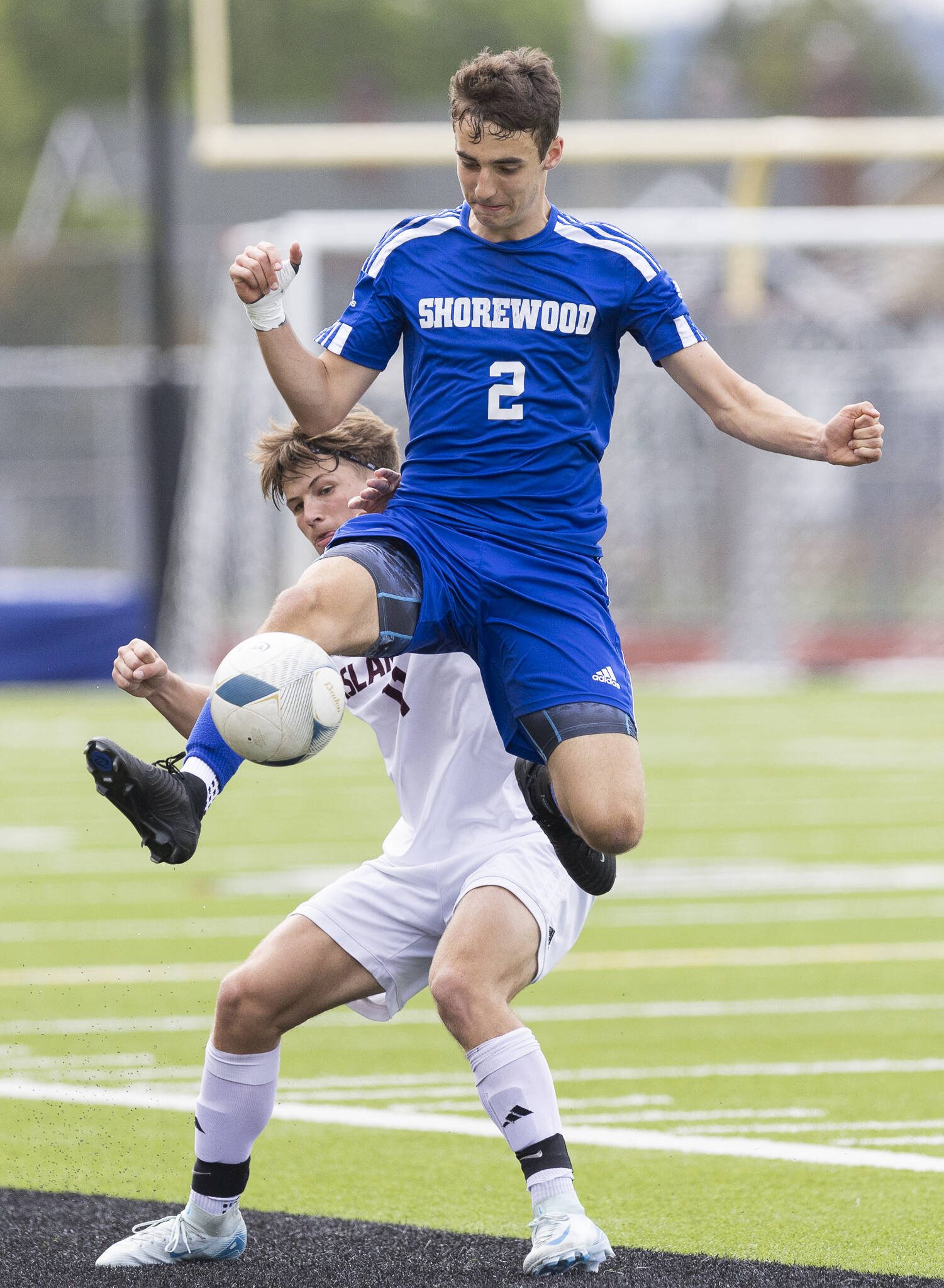 Shorewood’s George Clark leaps in the air to gain control of the ball during the 3A state championship game against Mercer Island on Saturday, May 31, 2025 in Puyallup, Washington. (Olivia Vanni / The Herald)