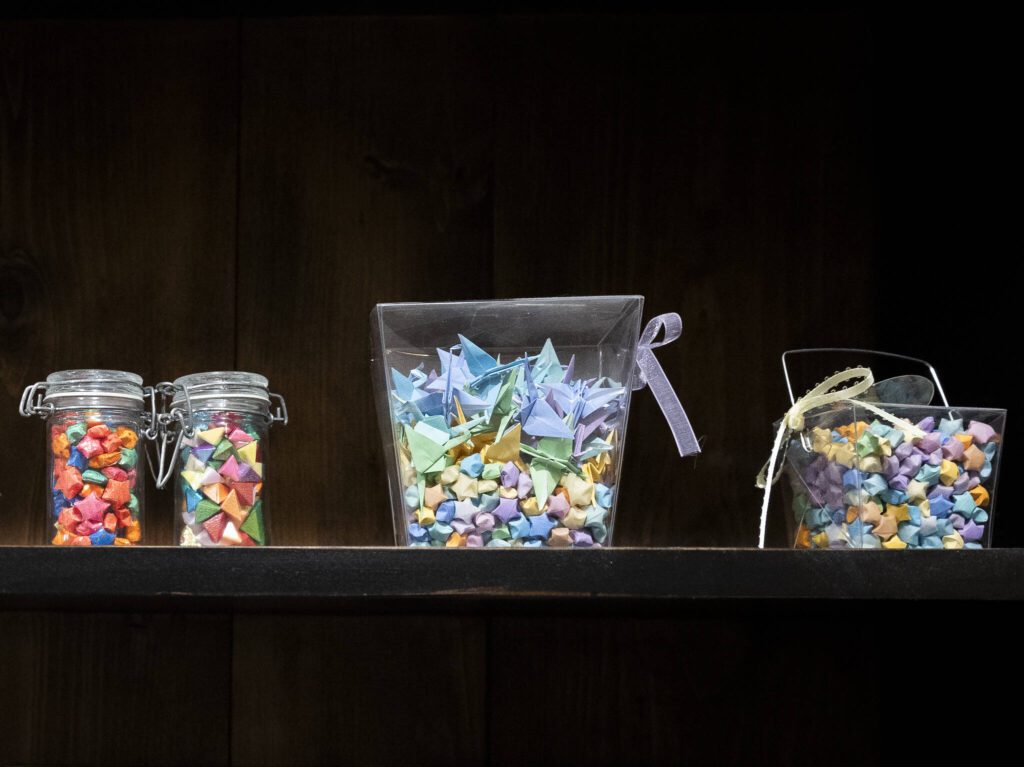 Containers filled will origami stars and cranes sit on display inside the Kim’s Crane showroom on Monday, Feb. 17, 2025, in Snohomish, Washington. (Olivia Vanni / The Herald)
