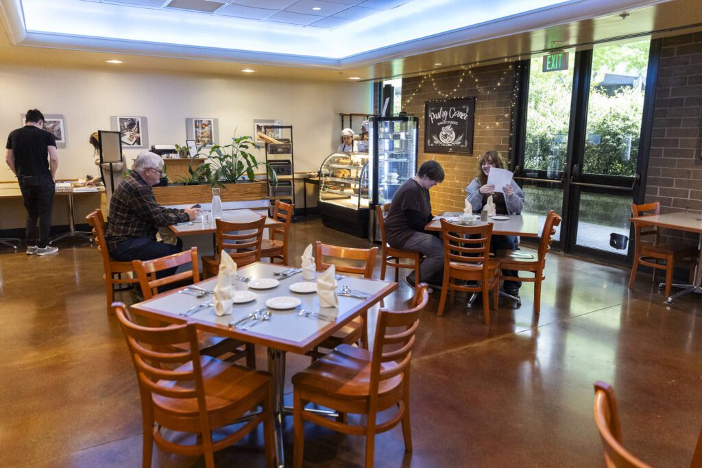 People sit inside at the Edmonds College Cafe on Thursday, May 29, 2025 in Lynnwood, Washington. (Olivia Vanni / The Herald)
