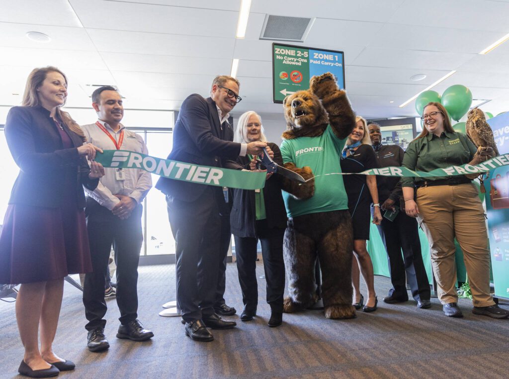 Propeller Airports CEO Brett Smith cuts a ribbon before the first Frontier Airlines flight departure at Paine Field Airport on Monday, June 2, 2025 in Everett, Washington. (Olivia Vanni / The Herald)
