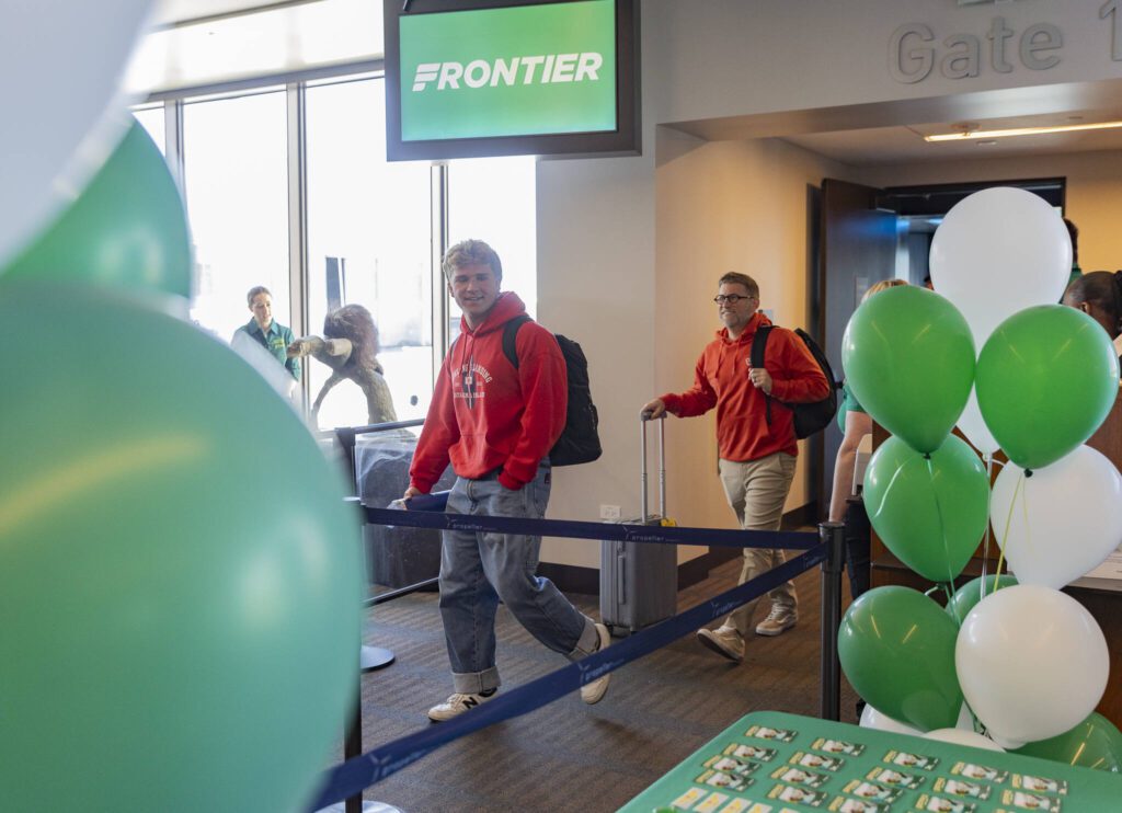 Chance Tuttle and father Rob Tuttle are some of the first passengers off of the first Frontier Airlines flight arriving at Paine Field Airport on Monday, June 2, 2025 in Everett, Washington. (Olivia Vanni / The Herald)
