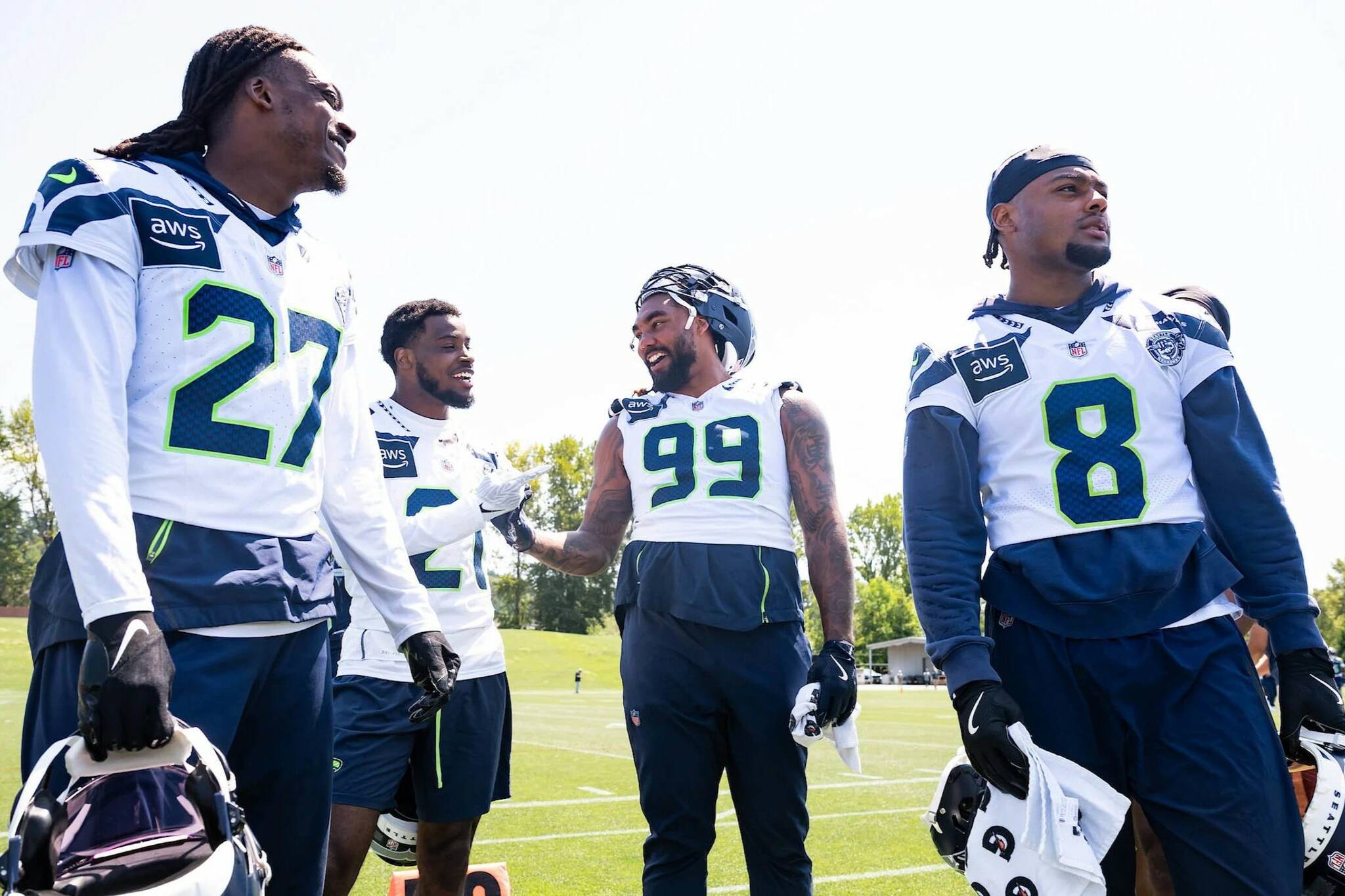 Seahawks cornerback Riq Woolen (27), cornerback Devon Witherspoon (21), defensive end Leonard Williams (99) and safety Coby Bryant (8) convene during Seahawks OTAs on Monday June 2, 2025 at the Virginia Mason Athletic Center. (Photo courtesy of Rod Mar / Seattle Seahawks)