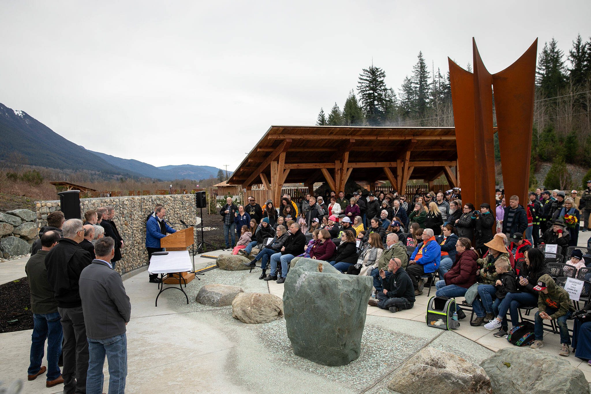 Community members gather for the dedication of the Oso Landslide Memorial following the 10-year remembrance of the slide on Friday, March 22, 2024, at the Oso Landslide Memorial in Oso, Washington. The Daily Herald’s “After the Slide” series, published in March 2024, took first place in the Environment and Natural Disaster Reporting category. (Ryan Berry / The Herald)