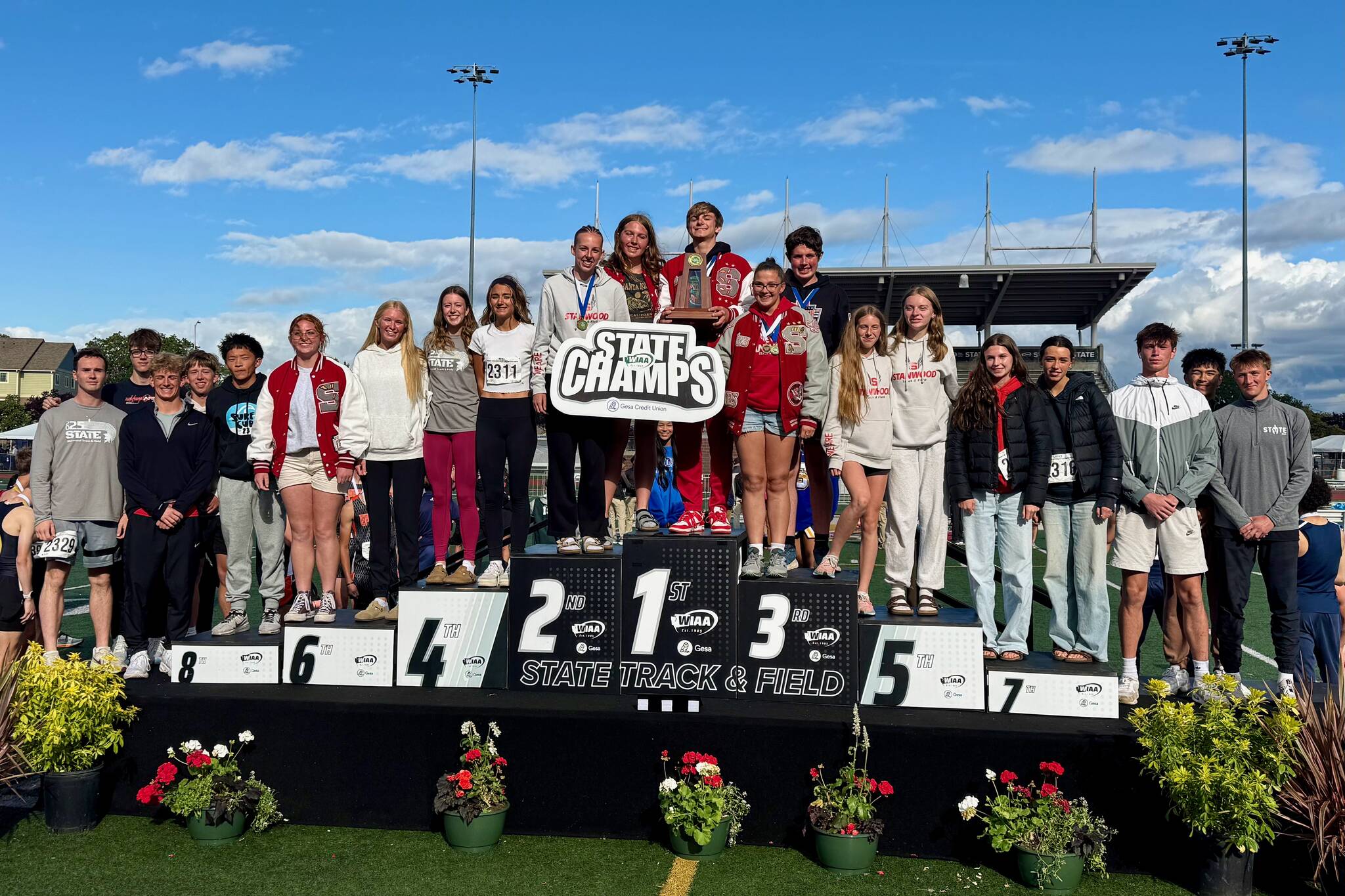 The Stanwood track & field team stands on the podium as they are crowned inclusive state champions at the WIAA Track & Field Championships in Tacoma, Washington on May 31, 2025. (Photo courtesy of Michael Randall / Stanwood Track & Field)