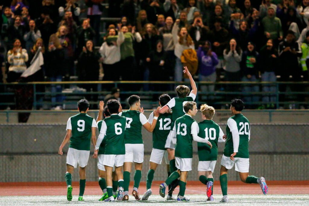 The Edmonds-Woodway boys soccer team, including sophomore midfielder Alex Plumis (13), celebrates a 4-3 win over Everett on May 1, 2023 at Edmonds-Woodway High School. (Courtesy of Edmonds-Woodway boys soccer / Michael Bury / Photobury)
