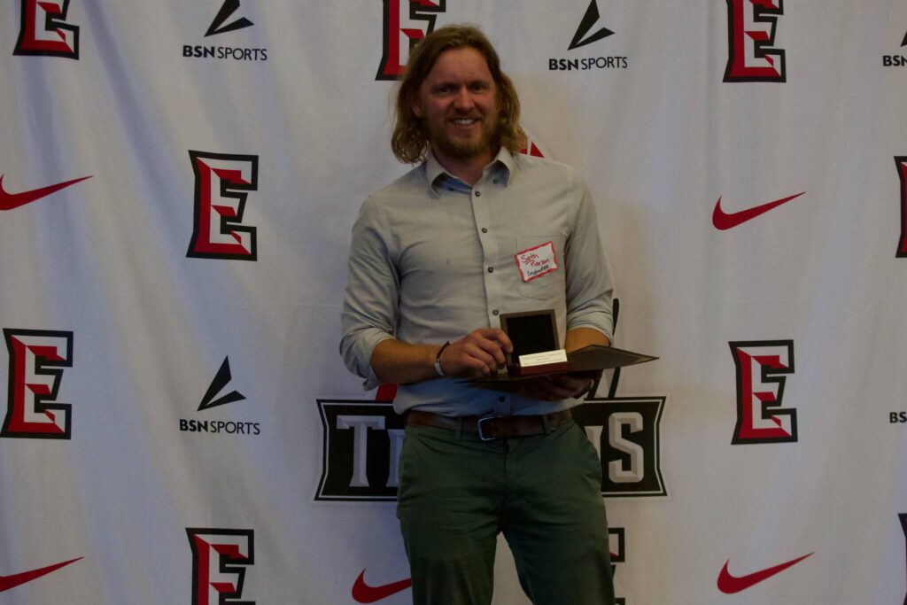 Seth Pierson poses with his award at the Everett Community College Athletics 2025 Hall of Fame Induction Ceremony in Everett, Washington on June 5, 2025. Pierson was a back-to-back conference champion in the 1500m in 2010 and 2011. (Joe Pohoryles / The Herald)
