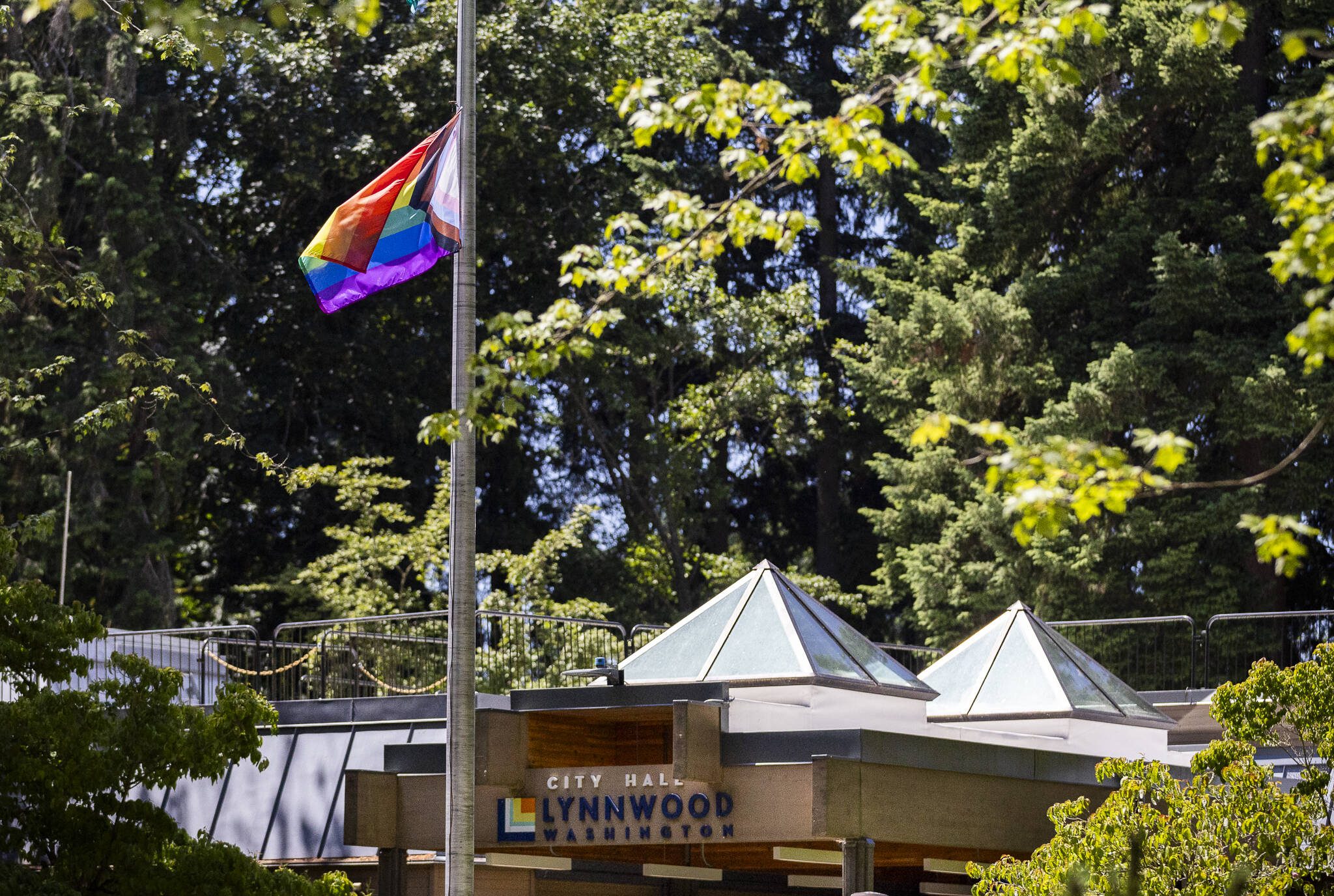 A rainbow LGBTQ+ pride flag hanging from a flag pole outside of Lynnwood City Hall moves in the wind on Tuesday, June 10, 2025, in Lynnwood, Washington. (Olivia Vanni / The Herald)