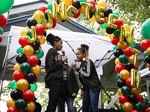 Junelle Lewis, right, daughter Tamara Grigsby and son Jayden Hill sing “Lift Every Voice and Sing” during Monroe’s Juneteenth celebration on Saturday, June 18, 2022. (Olivia Vanni / The Herald)