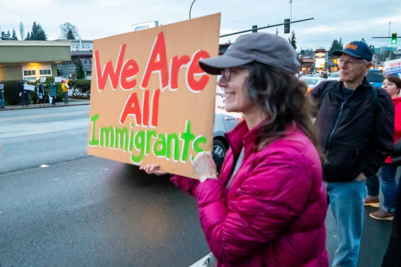 Hundreds lined Broadway with signs and chants to protest the Trump administration, Feb. 17 in Everett. (Aaron Kennedy / The Herald file photo)