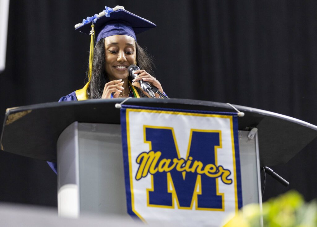 Senior class president Delina Belay smiles while speaking during Mariner High School’s 2025 commencement on Friday, June 13, 2025, at Angel of the Winds Arena in Everett, Washington. (Olivia Vanni / The Herald)
