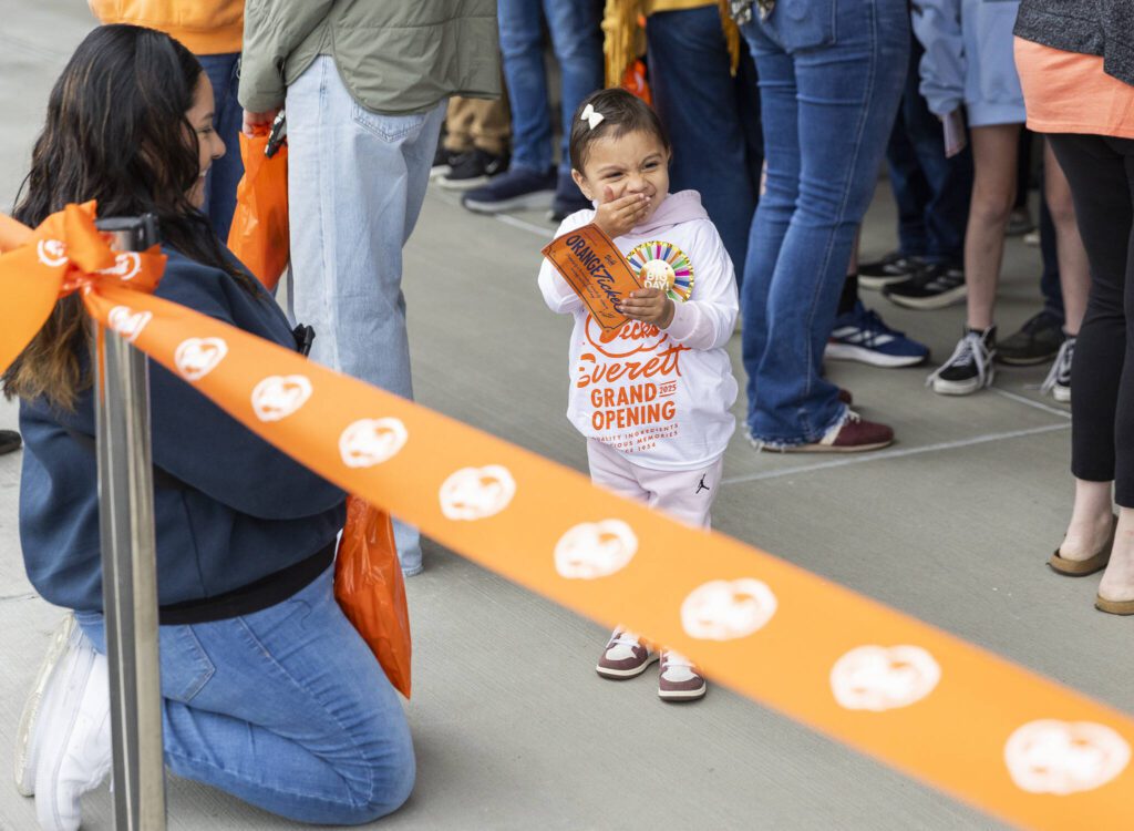 One of the orange ticket winners Gabriella Hernandez, 2, smiles before the ribbon cutting of the new Everett location of Dick’s Drive-In on Thursday, June 12, 2025 in Everett, Washington. (Olivia Vanni / The Herald)
